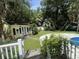 Well-maintained backyard with a pool, patio, garden, and bright yellow house at 3646 Hilton Dr, Johns Island, SC 29455