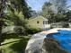 View of a backyard featuring pool, yellow house, and grassy yard at 3646 Hilton Dr, Johns Island, SC 29455