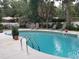 Inviting backyard pool surrounded by lounge chairs, lush greenery and tropical trees at 3646 Hilton Dr, Johns Island, SC 29455
