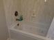This bright bathroom features a soaking tub with marble-tiled walls, creating a luxurious space at 3646 Hilton Dr, Johns Island, SC 29455