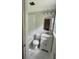 Bathroom featuring marble tiled shower and floors, complemented by a vanity and bright mirror at 3646 Hilton Dr, Johns Island, SC 29455