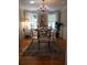 This dining room features hardwood floors, chandelier, colorful rug and a vintage Marilyn Monroe painting at 3646 Hilton Dr, Johns Island, SC 29455