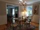 This dining room features hardwood floors, chandelier, colorful rug and a vintage Marilyn Monroe painting at 3646 Hilton Dr, Johns Island, SC 29455