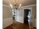 Inviting dining area with hardwood floors, chandelier, and views into the kitchen and living areas at 3646 Hilton Dr, Johns Island, SC 29455