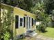 Charming yellow cottage with black shutters, double doors, and lush landscaping at 3646 Hilton Dr, Johns Island, SC 29455