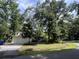 Charming yellow home with mature trees, landscaping, and a two-car garage at 3646 Hilton Dr, Johns Island, SC 29455