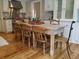 Spacious kitchen with wooden table and chairs, white cabinets, and granite countertops, and hardwood floors at 3646 Hilton Dr, Johns Island, SC 29455