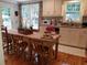 Cozy kitchen featuring white cabinets, granite countertops, wood floors and breakfast table with chairs at 3646 Hilton Dr, Johns Island, SC 29455