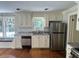 Bright kitchen featuring white cabinets, stainless steel appliances, granite countertops, and pool views at 3646 Hilton Dr, Johns Island, SC 29455
