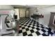 Commercial kitchen with stainless steel appliances, three-basin sink, and black and white checkered flooring at 3646 Hilton Dr, Johns Island, SC 29455