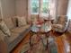 Inviting living room with hardwood floors, neutral colored sofa, wingback chairs, and round glass table at 3646 Hilton Dr, Johns Island, SC 29455