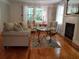 Cozy living room with hardwood floors, fireplace, comfortable seating, and bright windows at 3646 Hilton Dr, Johns Island, SC 29455