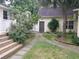 Well-maintained yard and landscaping with a walkway, lush greenery, and a storage shed at 3646 Hilton Dr, Johns Island, SC 29455