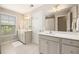 Double sink bathroom with white cabinetry, mirrors, and tile flooring at 4117 Rigsby Ln, Charleston, SC 29414