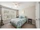 Bright bedroom boasts a ceiling fan and leafy views from its large window at 4117 Rigsby Ln, Charleston, SC 29414