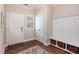 Inviting entryway with wood floors, coat rack and storage, and white trim at 4117 Rigsby Ln, Charleston, SC 29414