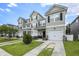 Well-manicured townhomes with attached garages, sidewalks, and landscaping, providing curb appeal at 4117 Rigsby Ln, Charleston, SC 29414