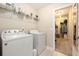 Functional laundry room with washer, dryer, and storage shelving at 4117 Rigsby Ln, Charleston, SC 29414