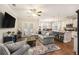Open-concept living room and kitchen featuring hardwood floors and stainless steel appliances at 4117 Rigsby Ln, Charleston, SC 29414