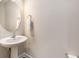 Cozy powder room with pedestal sink, decorative mirror, and neutral paint at 4117 Rigsby Ln, Charleston, SC 29414