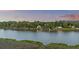 Aerial view of homes along the waterway surrounded by lush greenery at sunset at 4940 Lambs Rd, North Charleston, SC 29418