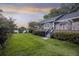 Relaxing backyard with a brick patio, lush green grass, and a view of the water at 4940 Lambs Rd, North Charleston, SC 29418