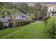 Lush backyard with mature trees, green lawn, and a fence, offering privacy and serenity at 4940 Lambs Rd, North Charleston, SC 29418