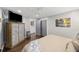 This bedroom has hardwood floors, a ceiling fan, and beach-themed art and decor at 4940 Lambs Rd, North Charleston, SC 29418
