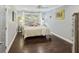 This bedroom features beautiful hardwood floors, neutral walls, and a ceiling fan at 4940 Lambs Rd, North Charleston, SC 29418