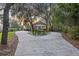 Charming home surrounded by lush trees with circular driveway entrance at 4940 Lambs Rd, North Charleston, SC 29418