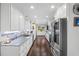 Bright, updated kitchen featuring granite countertops, white cabinets, and stainless steel appliances at 4940 Lambs Rd, North Charleston, SC 29418