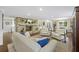 Bright and airy living room with hardwood floors, exposed brick fireplace, and neutral furnishings at 4940 Lambs Rd, North Charleston, SC 29418