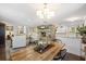 Open-concept living room and dining room with exposed brick fireplace and hardwood floors at 4940 Lambs Rd, North Charleston, SC 29418
