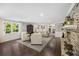 Spacious living room featuring fireplace, neutral furniture, and large windows at 4940 Lambs Rd, North Charleston, SC 29418