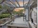 Inviting outdoor patio with pergola, swing, and comfortable seating, ideal for relaxing by the water at 4940 Lambs Rd, North Charleston, SC 29418