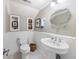 This powder room has wainscotting, a pedestal sink, and white walls and trim at 4940 Lambs Rd, North Charleston, SC 29418