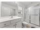 Bright bathroom features a glass-enclosed shower, white cabinets, and a large vanity at 5024 Blair Rd, Summerville, SC 29483