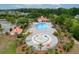 Aerial shot of a community pool area showcasing a pool, splash pad, and surrounding amenities at 5024 Blair Rd, Summerville, SC 29483