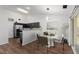 A dining area features modern lighting and a kitchen with stainless steel appliances at 5024 Blair Rd, Summerville, SC 29483