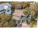 Aerial view of a two-story home surrounded by mature trees and featuring a spacious deck at 504 W Ashley Ave, Folly Beach, SC 29439