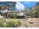 Charming backyard featuring a patio area with lounge chairs and lush landscaping at 504 W Ashley Ave, Folly Beach, SC 29439
