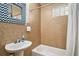 Updated bathroom with stylish tile, mirror, pedestal sink, and tub at 504 W Ashley Ave, Folly Beach, SC 29439
