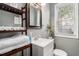 Compact bathroom with modern sink, a large mirror, and open shelving for convenient storage at 504 W Ashley Ave, Folly Beach, SC 29439