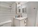 Stylish bathroom with a modern vanity, shelving, and well-lit mirror at 504 W Ashley Ave, Folly Beach, SC 29439