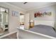 Cozy bedroom featuring a queen bed, ceiling fan, and views into the living room at 504 W Ashley Ave, Folly Beach, SC 29439