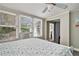 Bright bedroom with large windows, ceiling fan, and view to the yard outside at 504 W Ashley Ave, Folly Beach, SC 29439