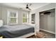 Comfortable bedroom featuring large windows, ceiling fan, and a well-appointed closet at 504 W Ashley Ave, Folly Beach, SC 29439