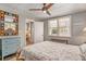Serene bedroom with natural light, a blue dresser, and a modern mirror, creating a calming and stylish space at 504 W Ashley Ave, Folly Beach, SC 29439