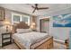 Comfortable bedroom boasts a ceiling fan, stylish bedside tables, and a charming painting, creating a welcoming ambiance at 504 W Ashley Ave, Folly Beach, SC 29439
