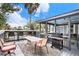 Outdoor deck with a grill, table with chairs and a view of the screened porch at 504 W Ashley Ave, Folly Beach, SC 29439